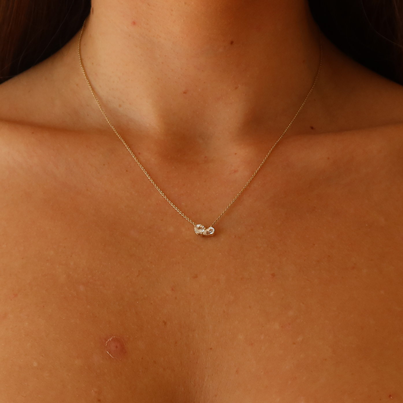 Toi et Moi gold necklace with white sapphire stones in 10 karat yellow gold