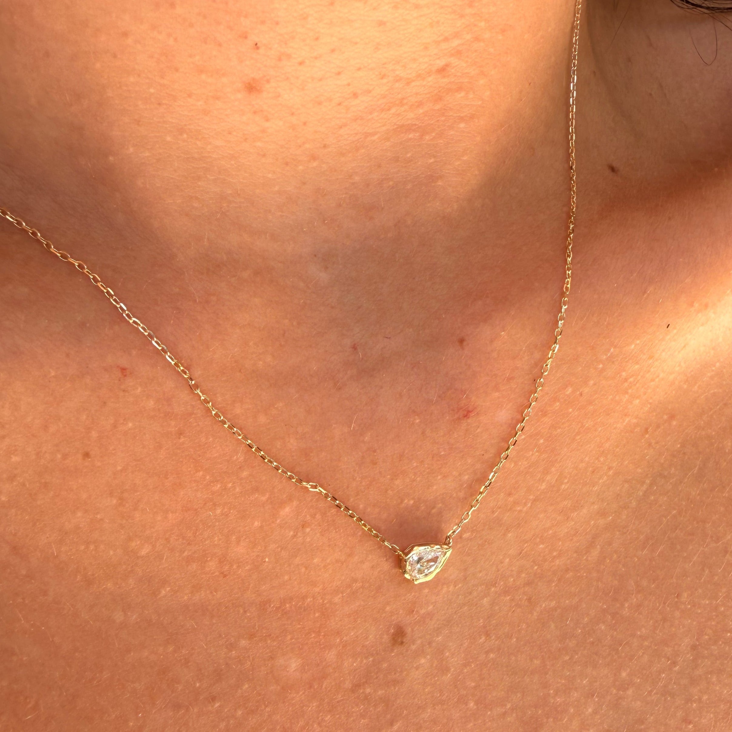 melted pear diamond bezel necklace in 10 karat yellow gold