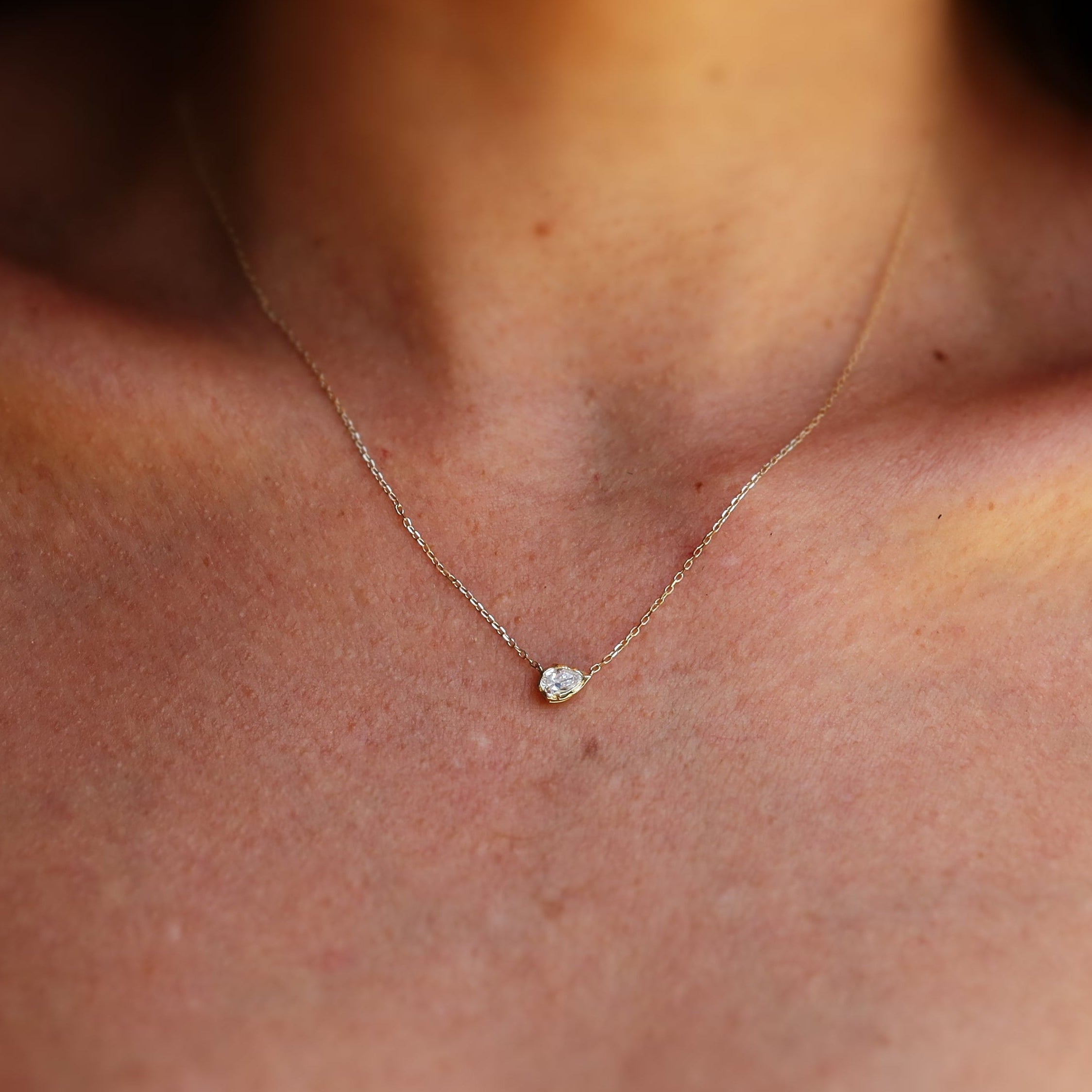 melted pear diamond bezel necklace in 10 karat yellow gold