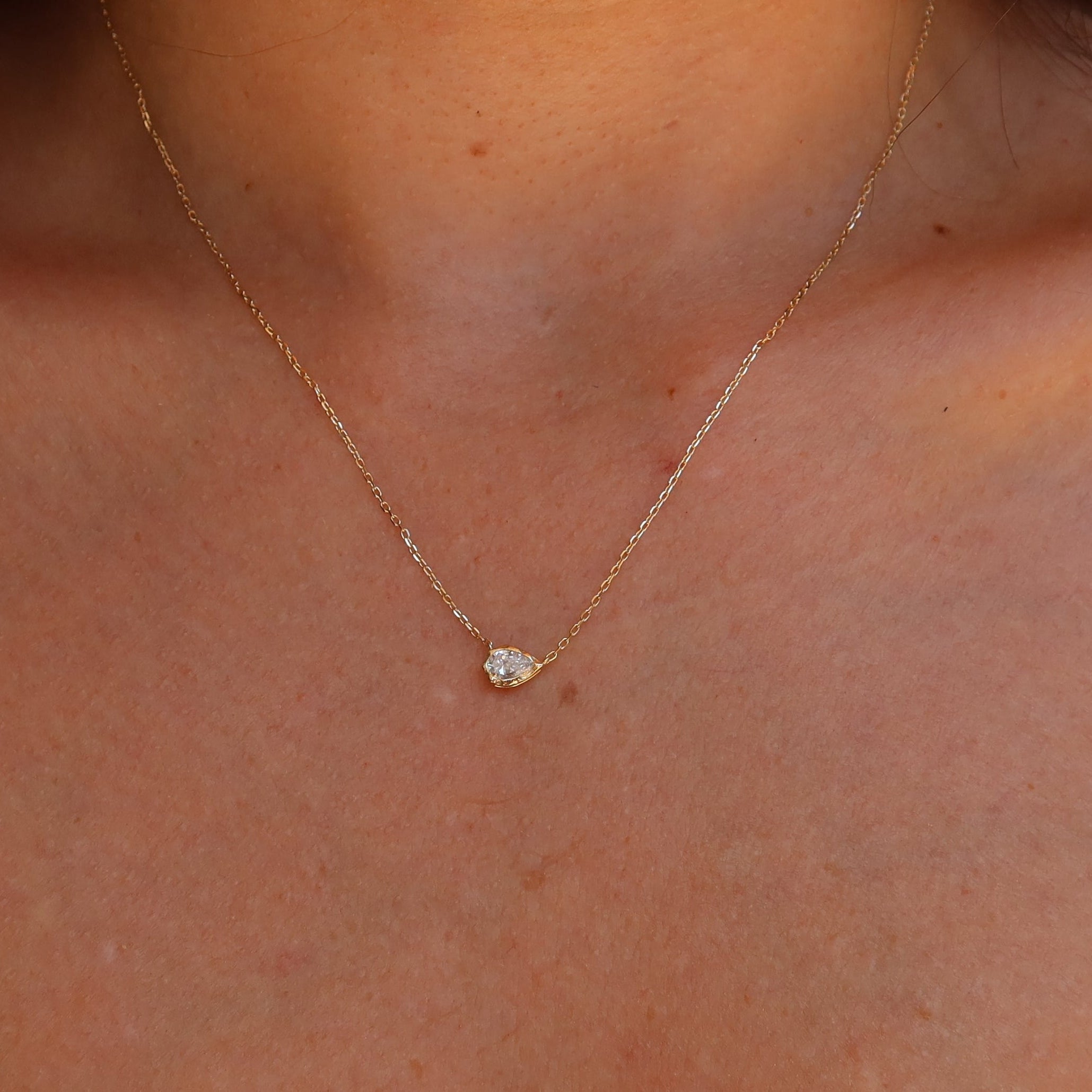 melted pear diamond bezel necklace in 10 karat yellow gold
