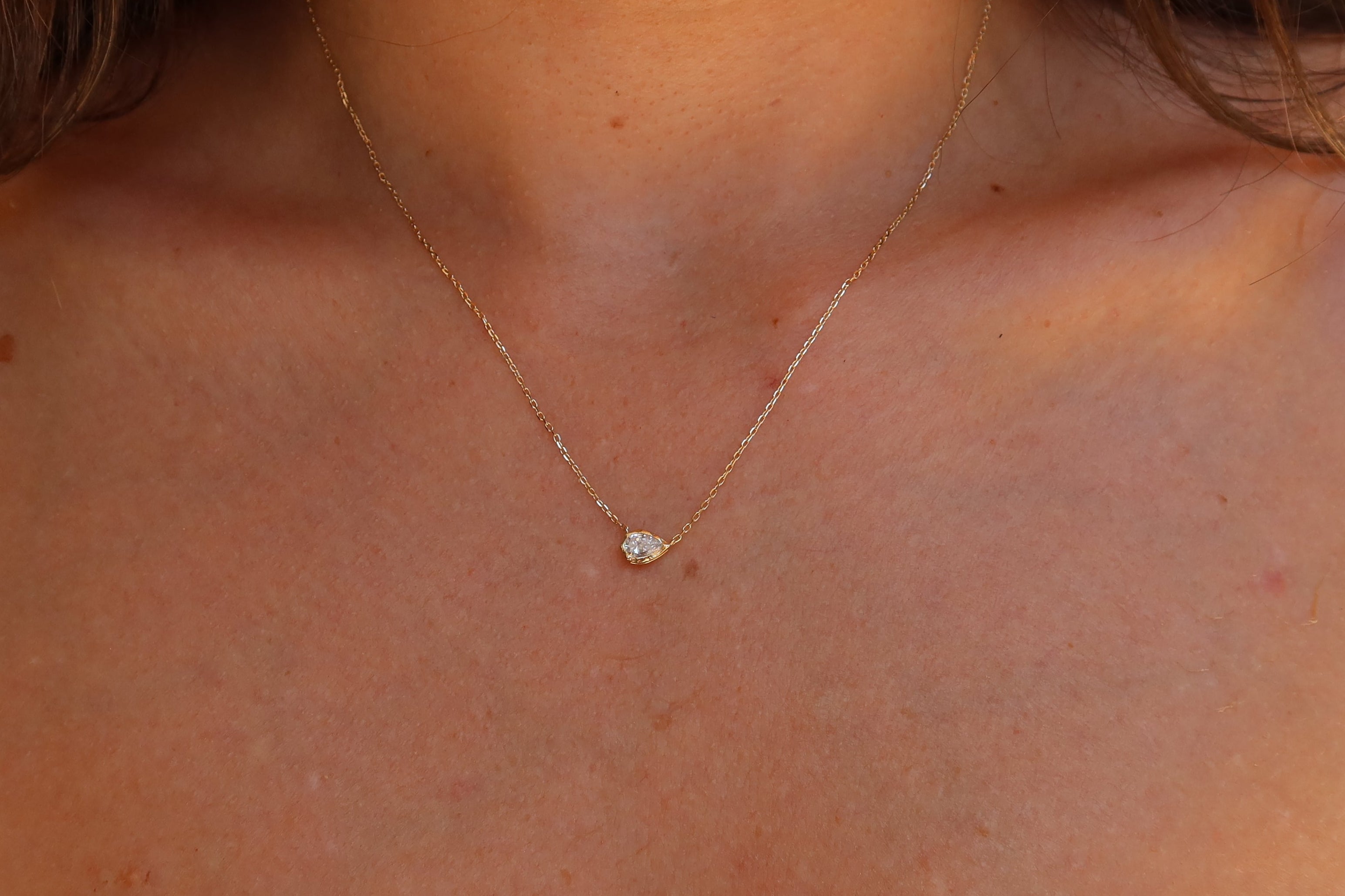 melted pear diamond bezel necklace in 10 karat yellow gold