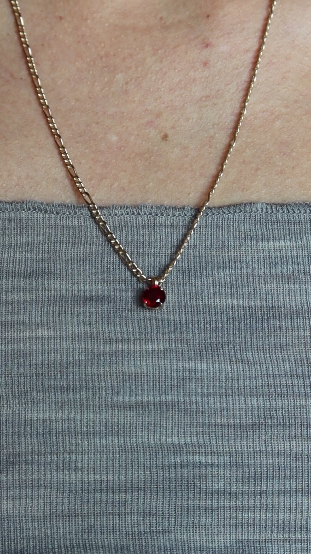 lab ruby pendant in 10 karat yellow gold worn with figaro gold chain