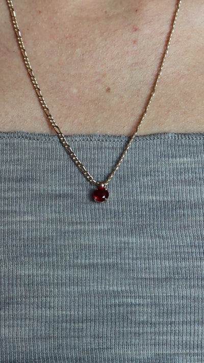 lab ruby pendant in 10 karat yellow gold worn with figaro gold chain